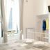 Sfumature Partenopee Naples guest room with bed, wall-mounted TV, open closet and tall windows
