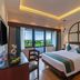 Sterling Karwar room with king bed, balcony and lush green view in Karwar