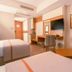 Venosa Beach Resort And Spa Didim guest room with twin beds, TV, desk and armchair