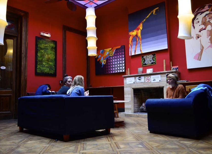 Art Factory San Telmo lobby lounge in Buenos Aires with blue sofas, fireplace, and colorful wall art
