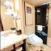 Ramada Plaza by Wyndham Tian Lu Hotel Wuhan bathroom with toilet, sink, and glass shower enclosure