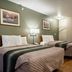 HomeTowne Studios by Red Roof Denver - Lakewood West room with two beds and kitchenette