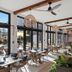The Clements Hotel Cambridge dining room with wicker chairs, woven pendant lights and patio views