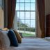 Laston House Ilfracombe bedroom with large window, sea view, and neatly made bed