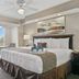 Silver Lake Resort in Kissimmee guest room with king bed, balcony view and ceiling fan