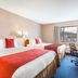 Ramada by Wyndham 100 Mile House room with two queen beds and a window view of the parking lot