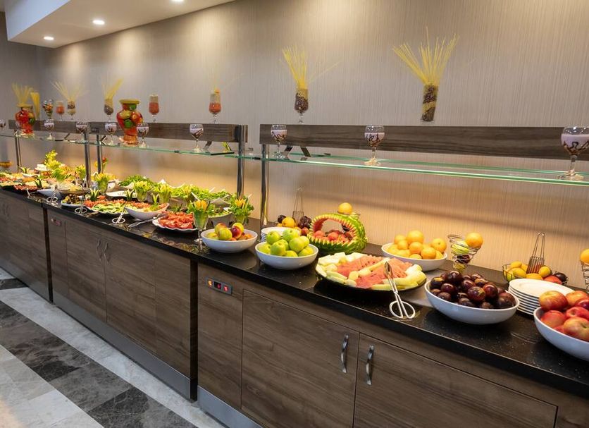 Extenso Hotel Izmir buffet with fresh fruit, salads and breakfast dishes on a long counter