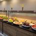 Extenso Hotel Izmir buffet with fresh fruit, salads and breakfast dishes on a long counter