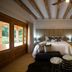 Visus Hotel Boutique & Spa in Fonda Central bedroom with king bed, wood-beam ceiling and garden view