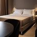 Didimos Town Hotel in Reggio Calabria guest room with double bed and bedside lamps