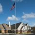 Residence Inn by Marriott Albany East Greenbush/Tech Valley exterior with flagpole and blue sky