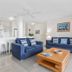 Private Apartments at Picture Point Noosa living room with two blue sofas and open kitchen in Noosa Heads