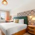 Beach Plaza Miami Beach guest room with bed, desk, window view and patterned headboard wall