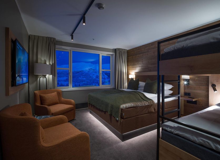 Skarsnuten Mountain Resort & Spa in Hemsedal guest room with bunk bed, armchairs and mountain view