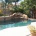 Happy Valley House Phoenix pool with rock waterfall and palm-lined backyard