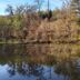 Waldhotel Silbermühle in Horn-Bad Meinberg beside a calm pond with autumn trees reflected in water