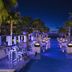 Breathless Riviera Cancun Resort & Spa in Puerto Morelos, lit pool walkway with palm trees at night