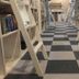 bnbplus Niigata Book Inn in Niigata, library-style hallway with bookshelves and checkered floor