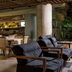 Movich Casa del Alferez in Cali lounge with dark cushioned chairs, dining tables and bar area