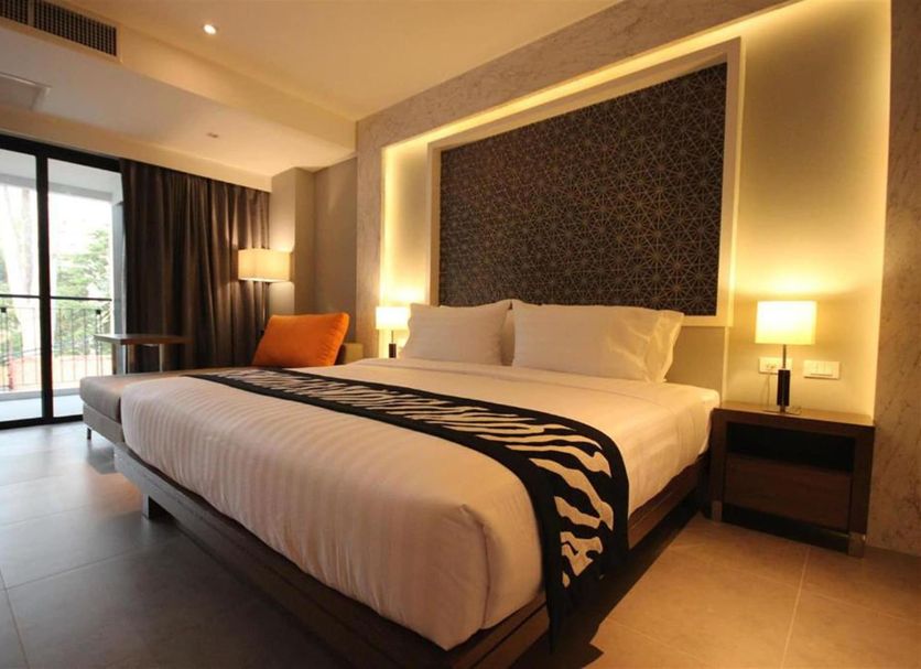 Season Five Hotel, Pattaya: modern guest room with king bed, floor-to-ceiling window, and balcony view