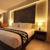 Season Five Hotel, Pattaya: modern guest room with king bed, floor-to-ceiling window, and balcony view
