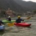 Bunk Stay Co-Working And Yoga in Rishikesh with kayakers on a river and hillside temples