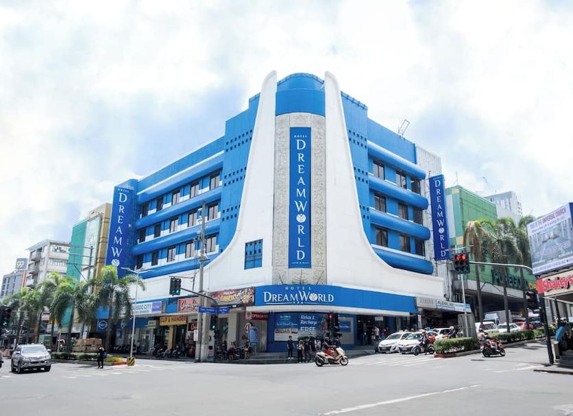 Hotel Dreamworld Araneta Cubao in Manila, blue-and-white corner hotel building on a busy city street