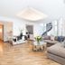 Living Hotel Prinzessin Elisabeth Munich lobby lounge with sectional sofa, glass table and spiral staircase