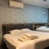 The Quay Hotel Bugis Singapore guest room with two beds, wall mirror and air conditioner