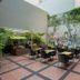 Whiz Hotel Malioboro Yogyakarta courtyard dining area with outdoor tables and wall mural in Yogyakarta