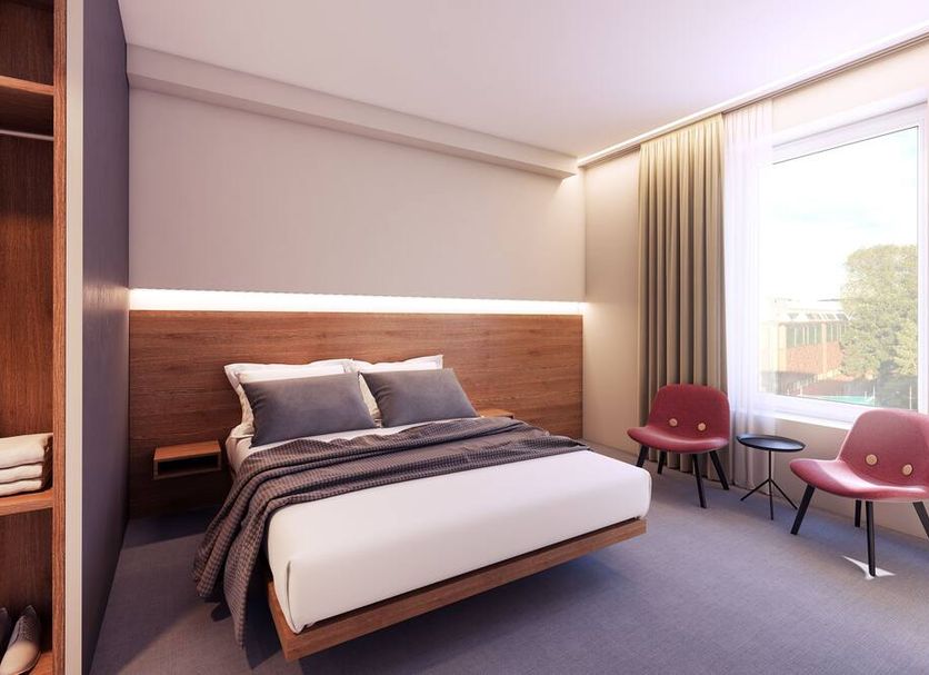 Thon Hotel Parken in Kristiansand guest room with bed, chairs, and large window
