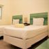 Inn at Tamarind Court in St. John: simple guest room with two twin beds and a window view of greenery