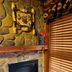 Cottage Inn At Lake Tahoe fireplace with stone surround and wooden blinds in Tahoe City