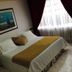 Hotel Bolivar Plaza, Manizales guest room with double bed, framed wall art and window curtains
