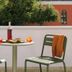 Gyotakuso Suzukiya in Minamiboso patio table with drinks and two green chairs beside a wall and trees