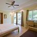 Mike's Dauin Dive Resort room with king bed, desk by window, and garden view in Dauin