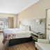 Red Roof Inn & Suites Fayetteville-Fort Bragg room with king bed, desk, TV, and window view