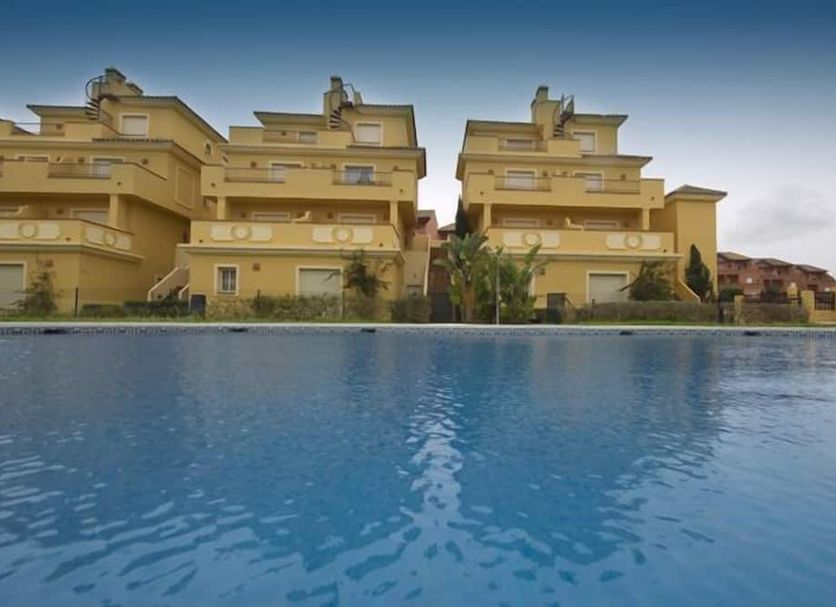 Poolfront view of Apartamentos Vista Real in La Línea de la Concepción with apartment buildings