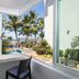 Hotel Villa Varadero in Nuevo Vallarta balcony with ocean view, palm trees, and pool walkway