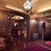 Rohotu Fare, Vaitape: wood-paneled lounge with leather chair, carved archway, and polished floor