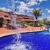 Frangipani Hotel Boutique in Brotas with outdoor pool, poolside loungers, and tropical palm trees