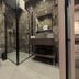 Hotel Aquarius Dubrovnik bathroom with walk-in glass shower, wall-mounted toilet and vanity in Dubrovnik