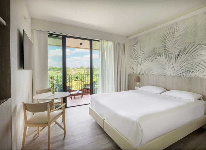 Una Hotels Forte Dei Marmi bedroom with balcony view and sliding glass doors in Forte dei Marmi