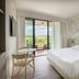 Una Hotels Forte Dei Marmi bedroom with balcony view and sliding glass doors in Forte dei Marmi