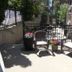 Outdoor patio with wicker seating and flower planters at The Medicine Hat Villa in Medicine Hat