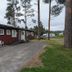 Örnvik Hotell & Konferens in Luleå, red lodge-style building with trees and parked vehicles