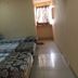 Vrp Guest House, Bhuj: simple guest room with three single beds and a window with curtains