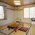 Villa Katashio in Nozawa Onsen: simple tatami room with low table, cushions, and large windows