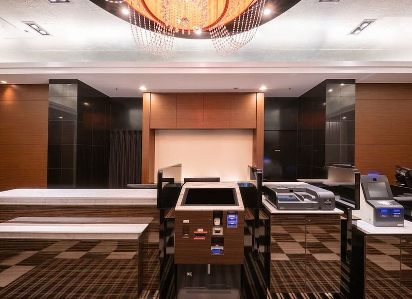 Apa Hotel Nagoya Marunouchi Ekimae lobby with self-check-in kiosks and modern ceiling lighting in Nagoya