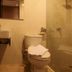 Vio Hotel Cimanuk Bandung bathroom with sink, toilet, and glass-enclosed shower in Bandung
